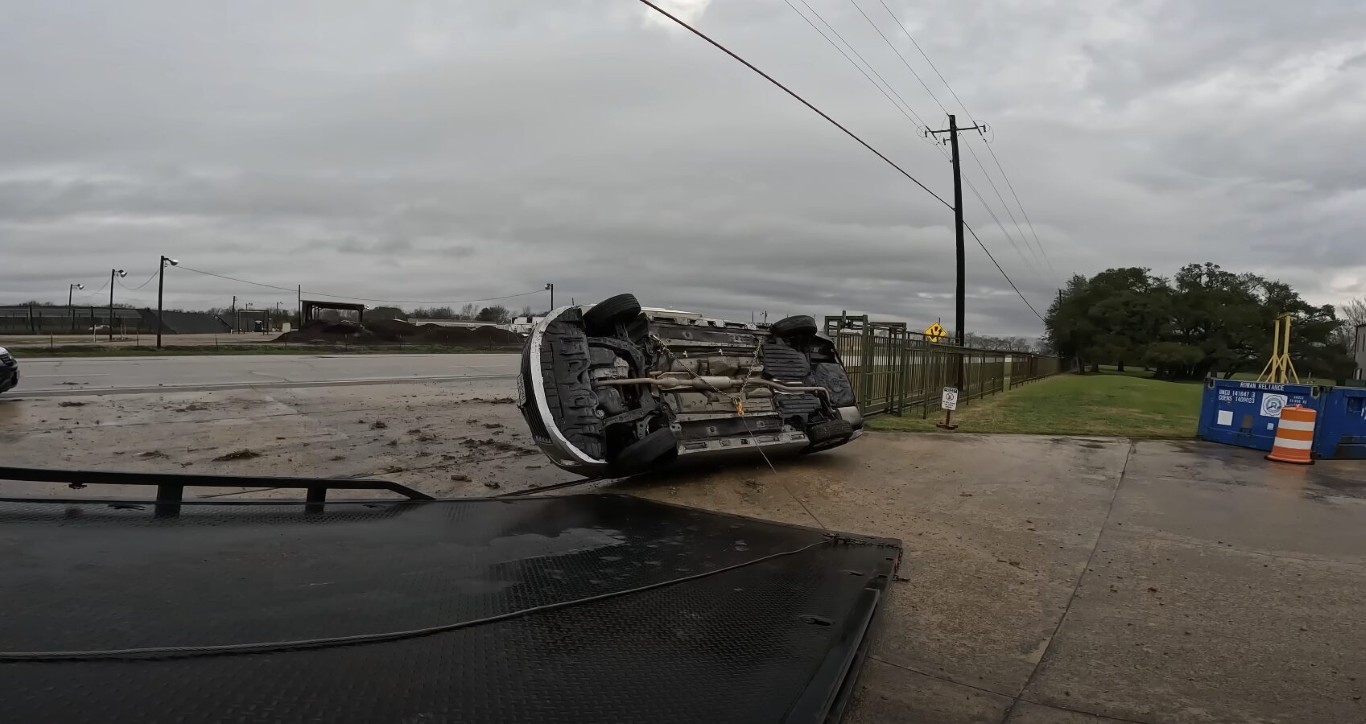 Accident recovery service handling overturned vehicle